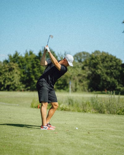 Eishockeyprofi Tim Stützle beim Abschlag auf dem Golfplatz